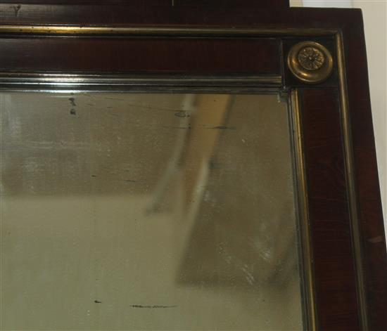 A French Empire style mahogany and brass mounted wall mirror, 3ft 11in. x 1ft 11.75in.